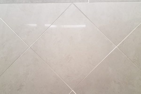 white tile wall with grout in the bathroom